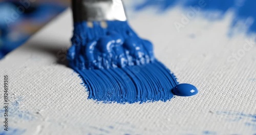 Wallpaper Mural Close-up of a paintbrush applying vibrant blue paint on a textured canvas background Torontodigital.ca