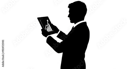 Silhouette of a man in a business suit holding a tablet
