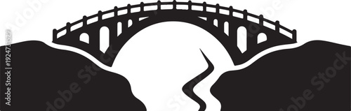 Black bridge silhouette over mountains and river at sunset