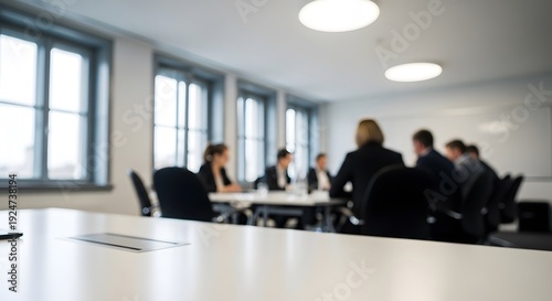 Blurry office meeting scene with people sitting around a table