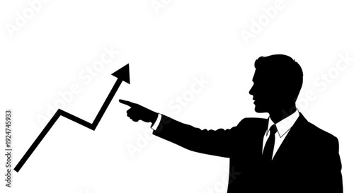 Silhouette of a businessman pointing at a rising graph arrow