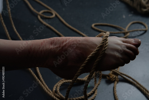 Photography Shibari art shown through ropes tied on a woman's foot in a simple space