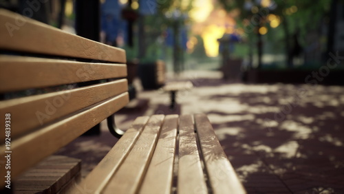 Konstfotografi A rustic wooden bench sits quietly in a serene park, surrounded by lush greenery