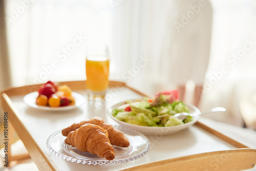 Tableau sur toile Exquisite Afternoon Tea Service with Croissants and Fresh Fruit