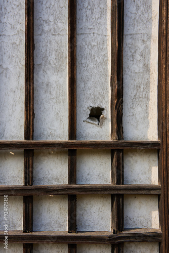 Weathered wooden lattice window of traditional Korean hanok