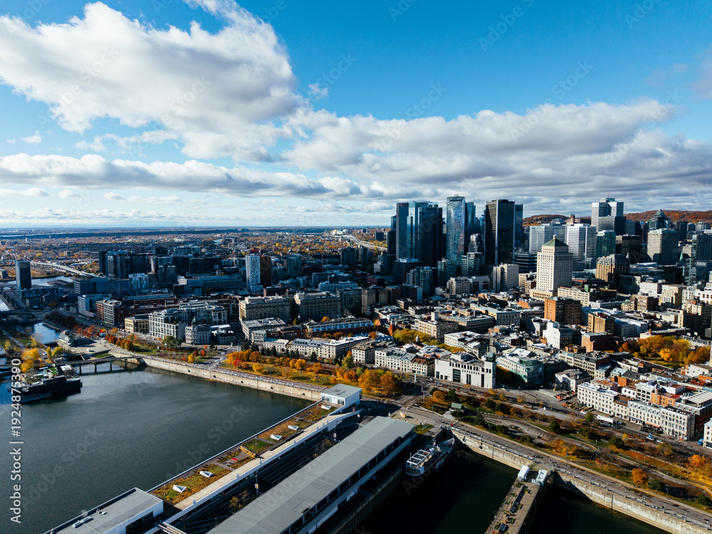 Obraz premium Aerial view of Montreal Old Port, downtown, historic buildings and waterfront under blue sky. g.