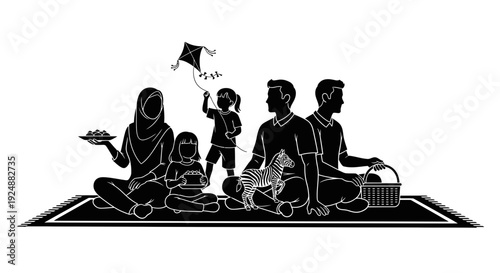 Family sitting on a mat outdoors flying a kite together happily