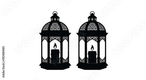 Two ornate black lanterns with lit candles inside side by side