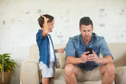 Photos Dad, child and ignore with phone on sofa for distraction, attention seeking or neglecting in home
