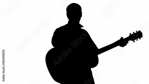 Silhouette of man playing acoustic guitar with skill