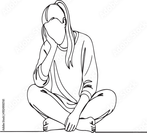 Young woman sitting cross-legged, hand on cheek, feeling pensive.