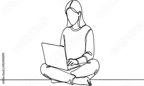 Young woman sitting cross-legged, working on a laptop computer.