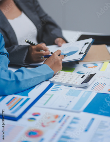 Auditor and accountant team working in office, analyze financial data and accounting record with calculator. Accounting company provide finance and taxation planning for profitable cash flow.