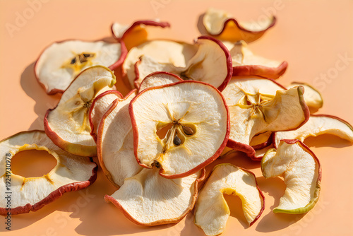 Dried apple slices on a peach background