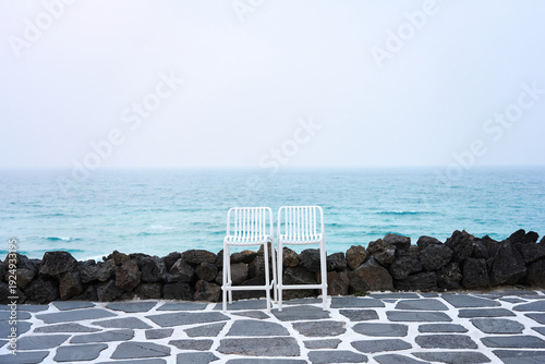 White Chairs Facing the Ocean with Copy Space