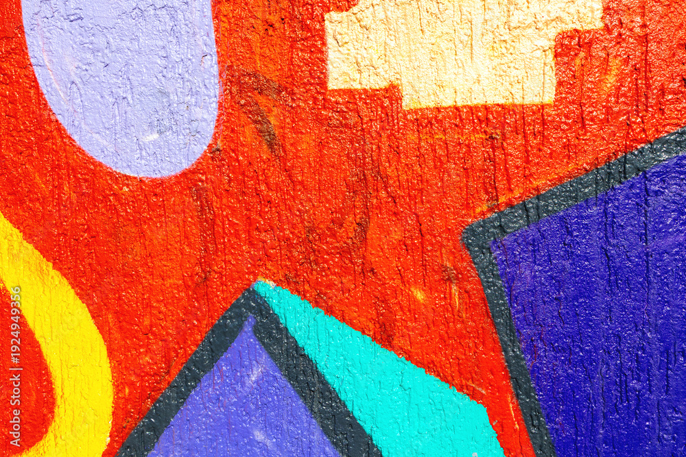 Fototapeta premium Bright colorful abstract graffiti mural with red, yellow, purple, blue shapes on wall surface. Urban grungy style, 90s, Y2K culture, street art, paint texture, city background, poster, mockup.