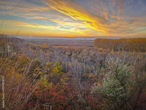 Fotografija Breathtaking autumnal landscape with a panoramic view of a valley at sunset
