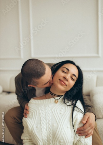 Tableau sur toile Loving couple sharing intimate moment on cozy sofa
