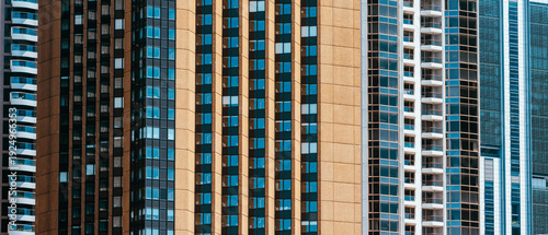 Fotografie Tight telephoto view of tall city apartment and office towers, repeating vertical patterns of windows and balconies