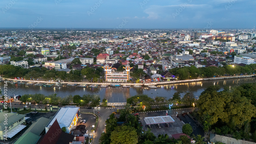 Obraz premium Aerial view of Banjarmasin showing city layout, buildings, and the 0KM monument along the riverbank