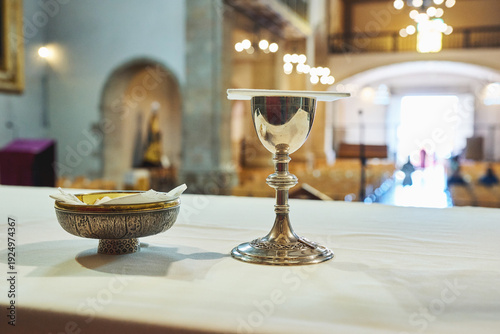 Fotografi Chalice and paten on altar table inside church