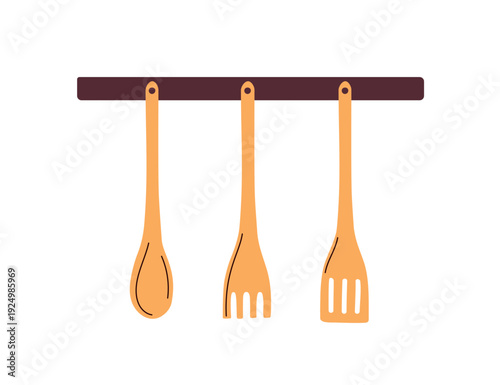 Wooden utensils on wall rack. Wood spoon, fork, spatula hanging on holder. Ki...