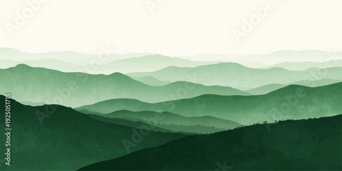 Misty mountain landscape at sunrise featuring a blue valley view with forest silhouettes under a haze of morning clouds and fog.