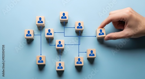 Hand placing wooden block with person connecting to network organization chart business structure team building