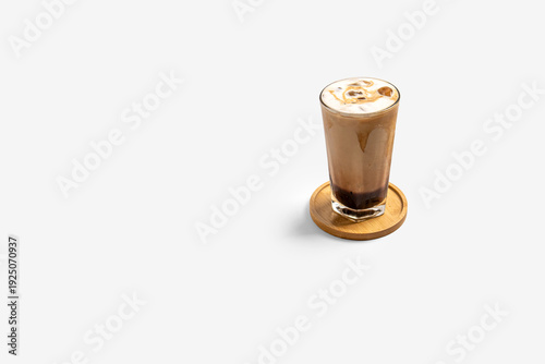 Palm sugar milk coffee iced ( kopi susu gula aren ) in glass isolated on white background. For cafe menu, banner, social ads, and branding.