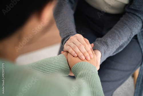 Psychologist or family holding hands to encourage patient with depression, mental health concept
