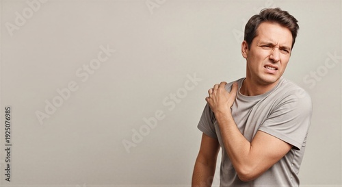 Man suffering from shoulder pain holding his arm. Concept of injury, discomfort, and health problem for medical illustration. 0072 gigapixel high fidelity v2 5536w