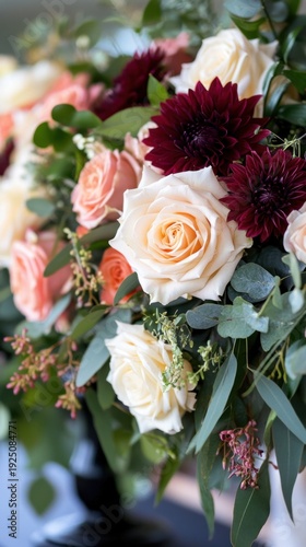 Elegant floral arrangement with roses and burgundy dahlias in lush greenery. Investiture Ceremony of the Captains Regent