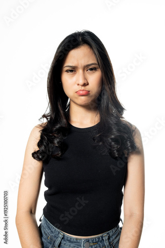 фотографія Young Asian woman with sad or pouting expression standing against white backgrou