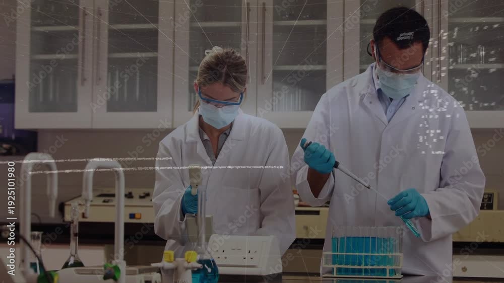Two lab techs dispensing and pipetting, device sending overlays over ...