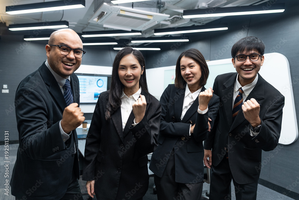 Fototapeta premium Happy diverse Asian business team analyzing financial statistics in office.