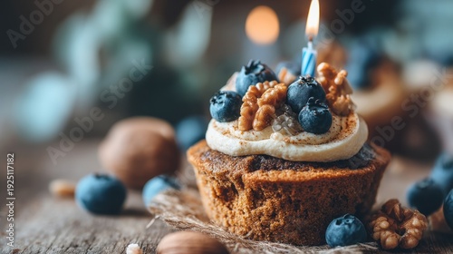Delicious cupcake with blueberries walnuts candle for birthday celebration close up