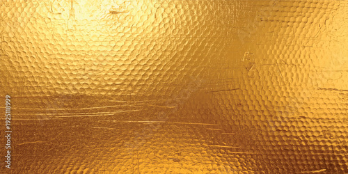 A textured gold surface with subtle variations in tone and a metallic, reflective appearance.