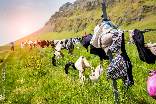 Famous funny roadside scene with a boot and bras in Iceland near the waterfall Skogafoss. Exotic countries. Popular tourist atraction.