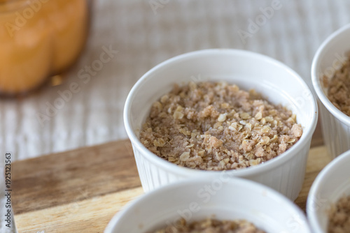 Freshly baked apple crumble in white ceramic ramekins