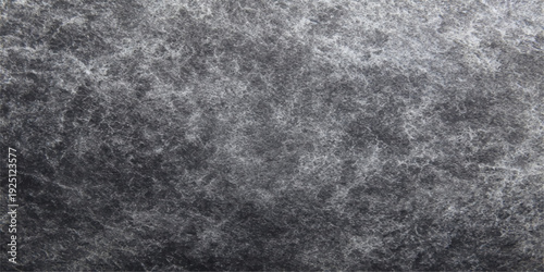 A dark grunge backdrop featuring a textured blend of black leather and fabric patterns on an aged gray stone surface with a vintage paper frame design