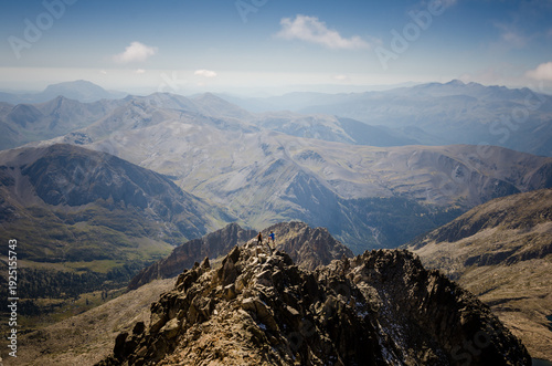 A couple of climbers on the summit of a mountain in the Pyrenees.