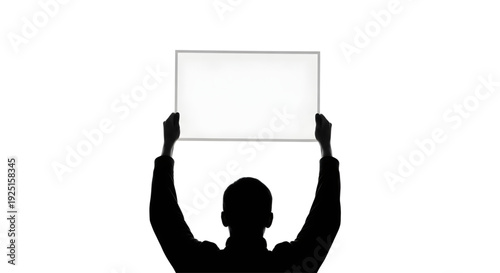 Silhouette of a person holding up a large blank horizontal sign for custom text or message