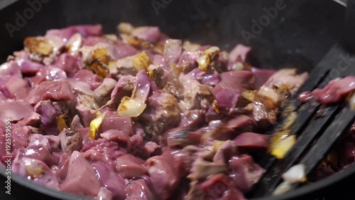 Fry chicken liver with onions in a hot frying pan. Chicken liver fried in a frying pan. Cooking. Chef. Homemade food.	
