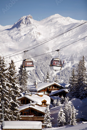 Ski lifts over the slopes of Courchevel ski resort, French alps by winter