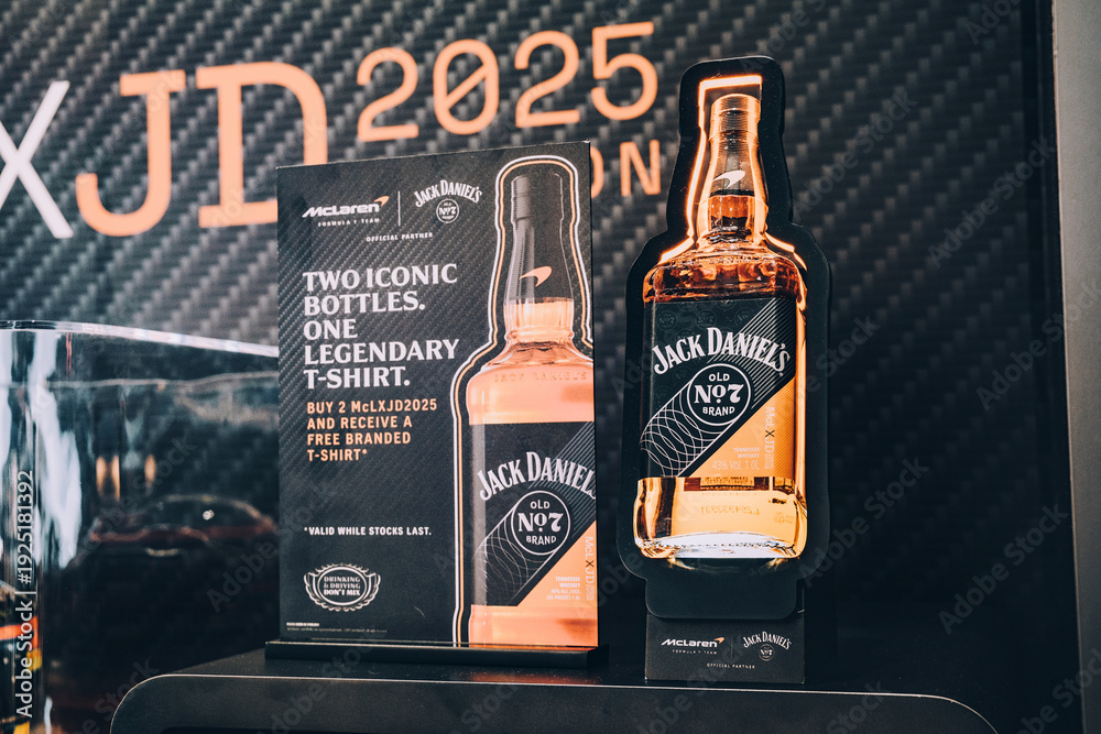 Naklejka premium 2 December 2025, Doha, Qatar: McLaren and Jack Daniel's partnership merchandise and whiskey bottles