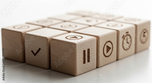 Productivity tracking wooden cubes aligned manually with natural depth and softly glowing blurred white environment.