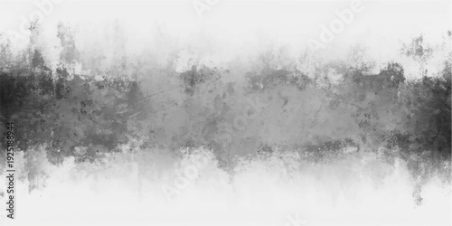 A misty morning landscape of black and white water drops on the grass near a cold lake with winter trees reflecting in the foggy river