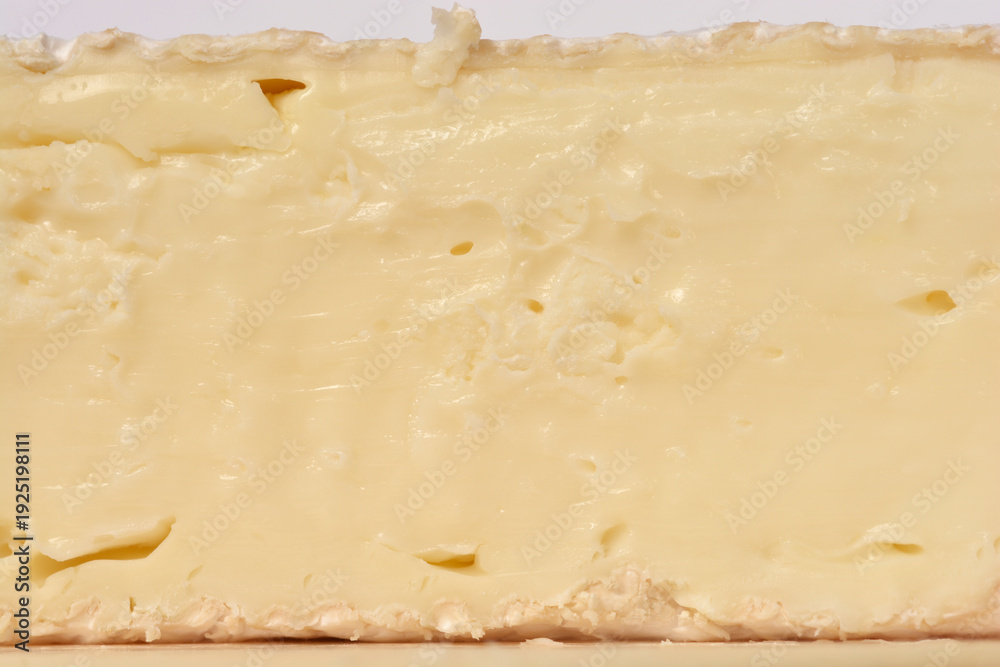 Ταπετσαρία A macro close up showing the creamy interior of a brie cheese wedge with small h