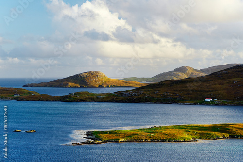 View S from near Allt Chrisal, Barra, to Vatersay near south tip of the Outer Hebrides, Scotland. Near start of Hebridean Way long distance walk