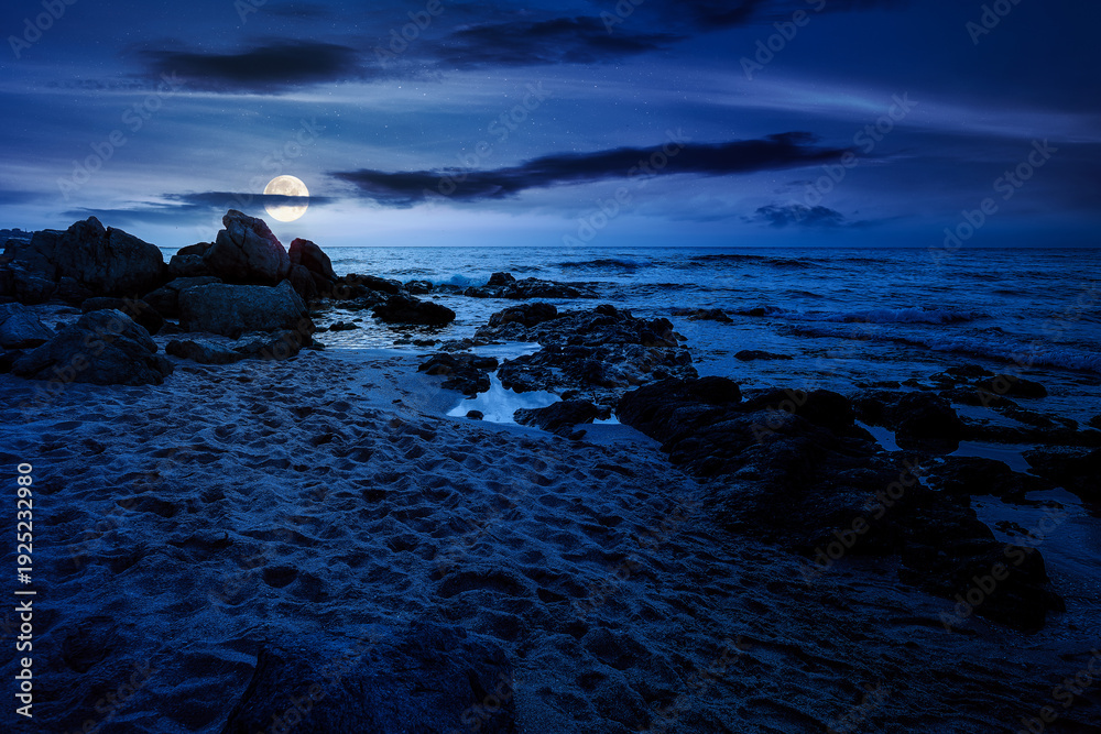 Fototapeta premium sandy beach landscape at night. full moon over coastal seascape scenery. mysterious nature background for summer vacation at the shore of black sea with rocks